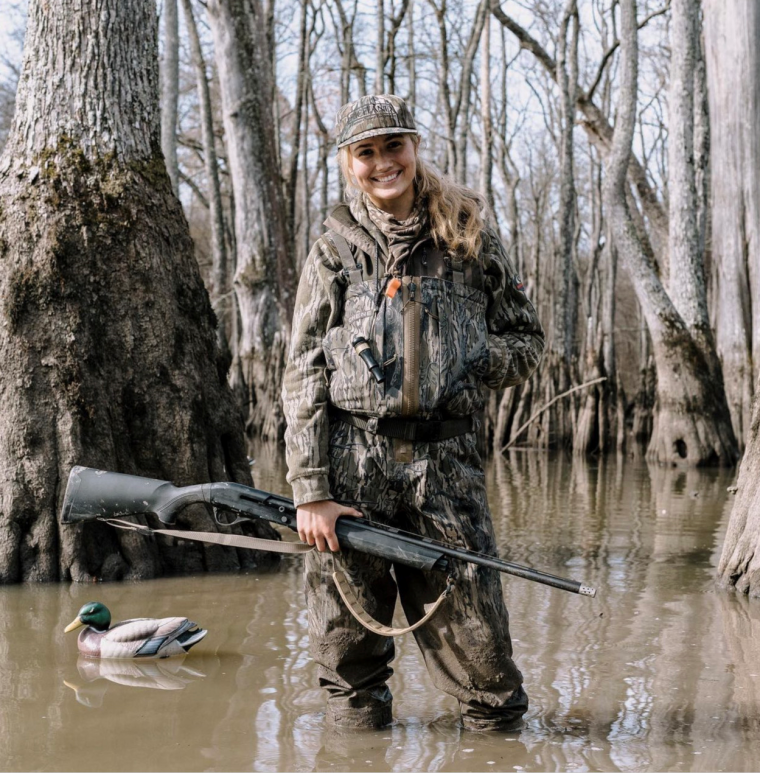 Female hunter in knee high water duck hunting